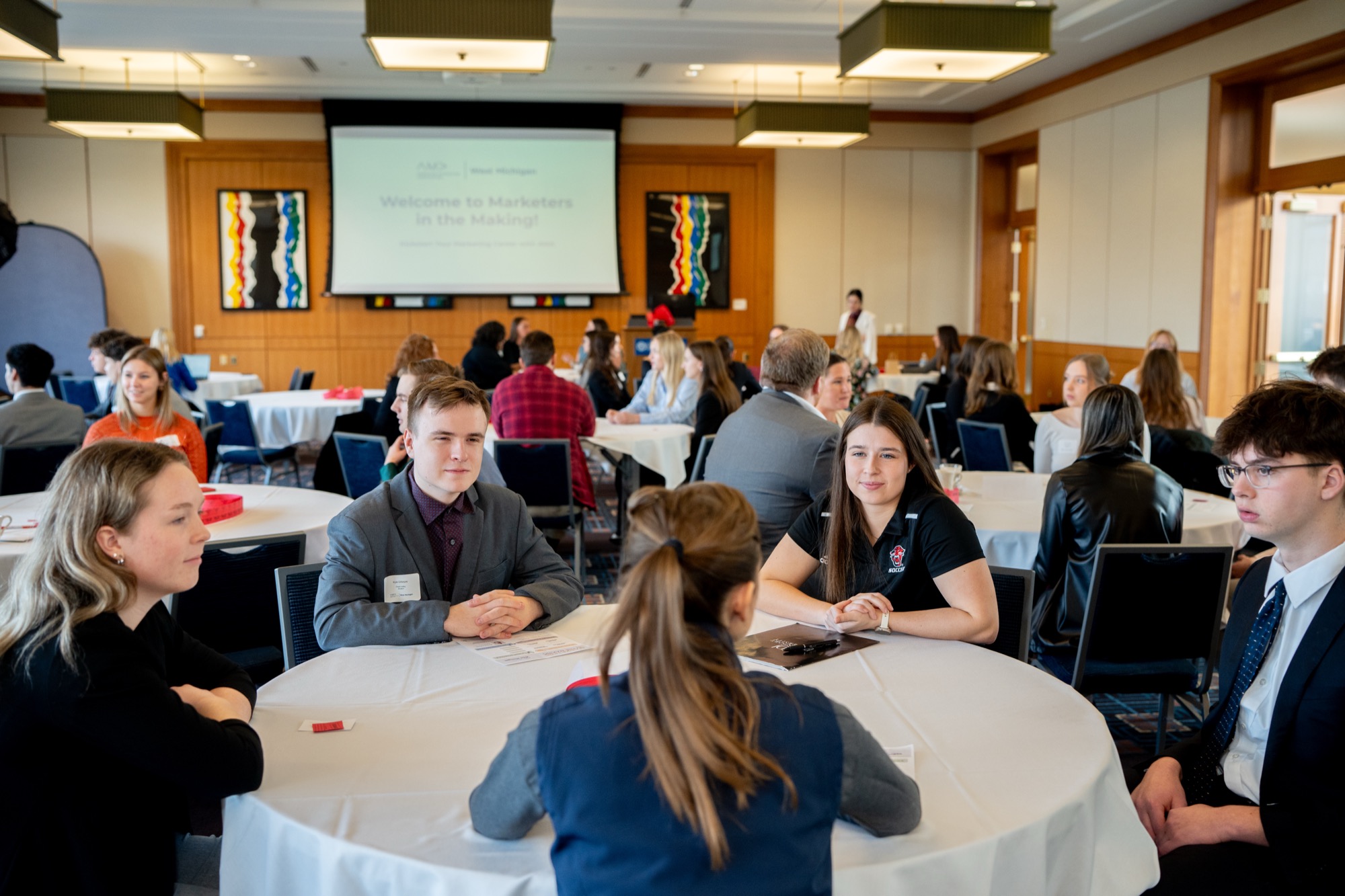 Students at round tables at the Marketers in the Making networking event
