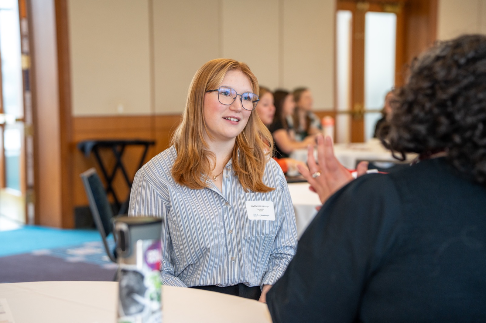 Two people in one-on-one conversation at a chapter event