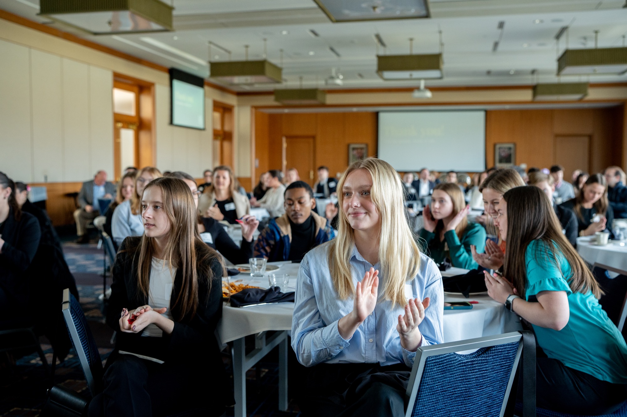 Members applauding a speaker at an AMA West Michigan event