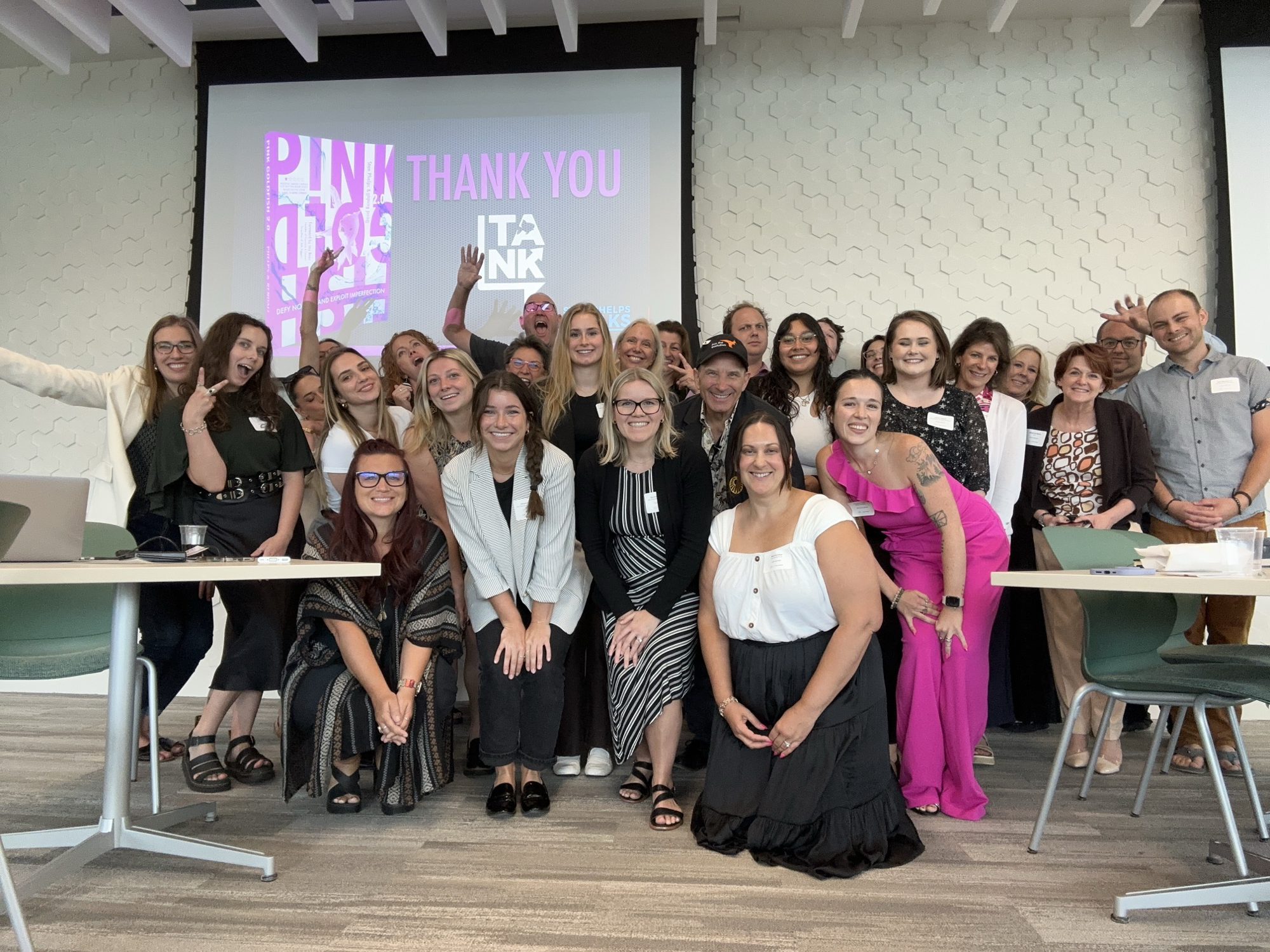 Group photo of attendees with author Stan Phelps in front of a thank-you slide