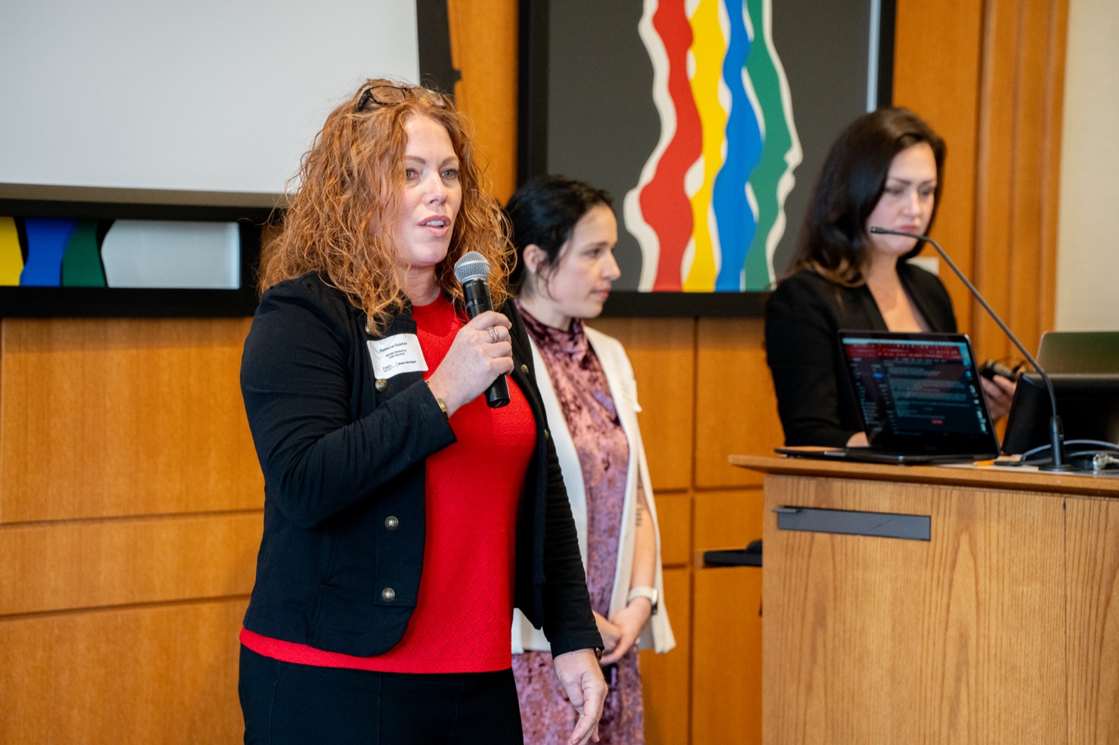 Speakers addressing attendees at an AMA West Michigan event